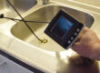 A person uses a camera to check on the status of their drain pipes