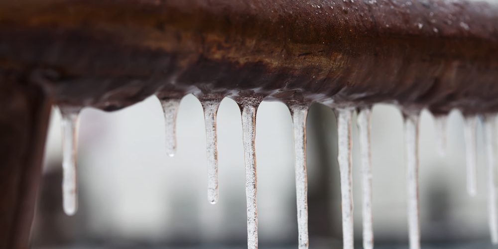 A closeup of a frozen brown pipe