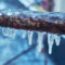 A closeup shot of a plumbing pipe that has been frozen over